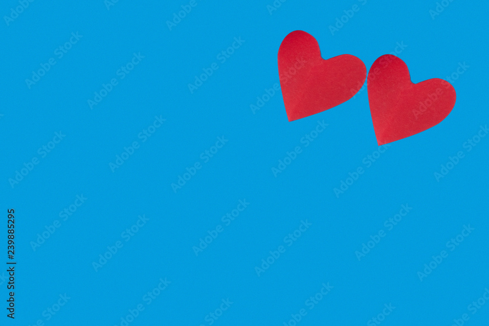 background for Valentine's day holiday, heart on blue background, couple of hearts on red and blue background