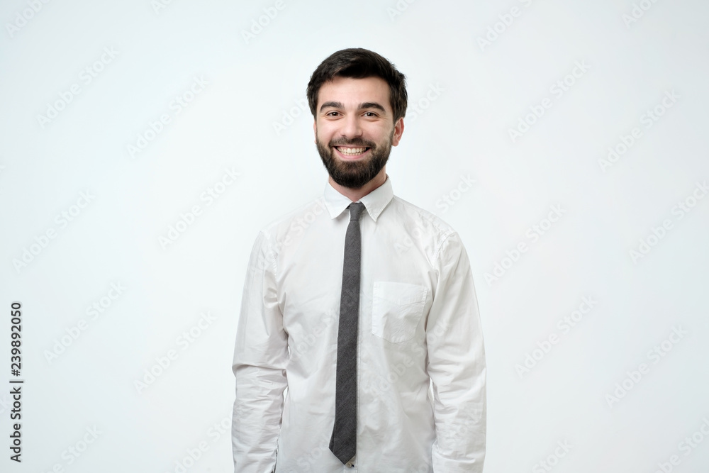 Young handsome business man over isolated background happy face smiling and looking at the camera. Positive person. Young handsome business man over isolated background happy face smiling and looking at the camera. Positive person.
