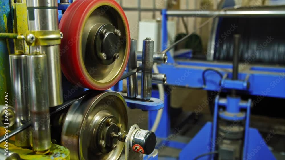 Manufacture of optical cable. Manufactured for the construction of buildings and provide electricity and internet. Machinery with high performance, precision and quality inside. Close up macro indoors