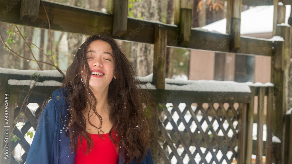Fototapeta premium Young asian teen standing in snow
