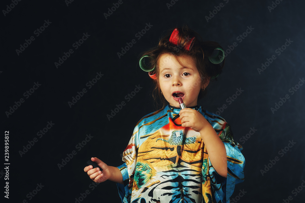 Portrait of a little fashionable girl in curlers .The concept of femininity Portrait of a little fashionable girl in curlers .The concept of femininity
