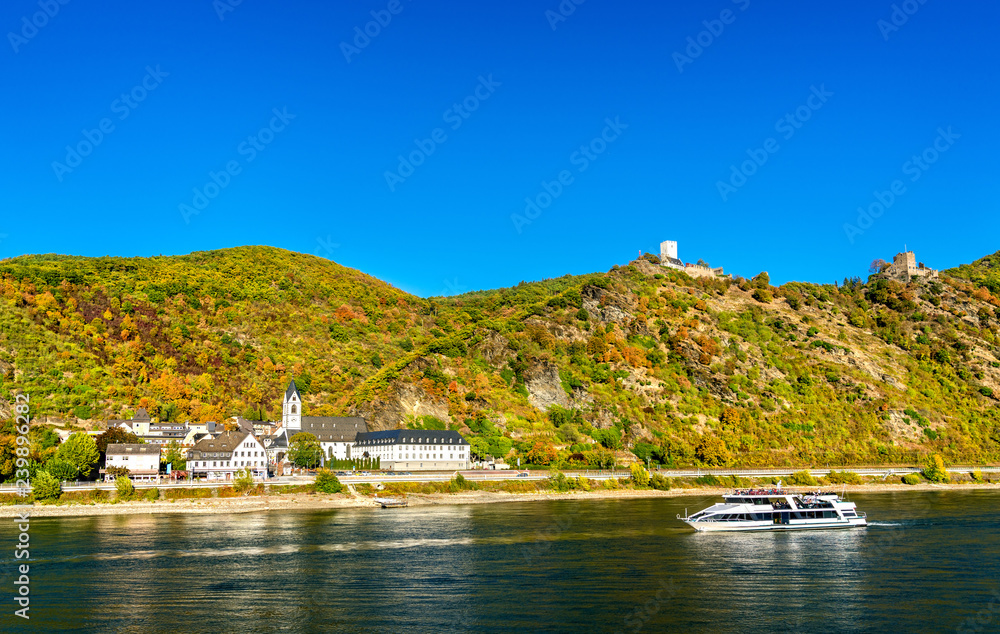 Cruise ship passes under Sterrenberg and Liebenstein Castles in the Rhine Gorge, Germany