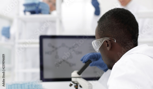 young scientist on the blurred background of modern laboratory