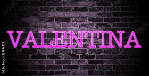 first name Valentina in pink neon on brick wall photo