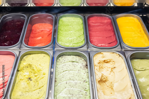 Assorted Varieties Of Gelato Or Ice Cream Made Of Natural Frozen Juice And Cream Or Coconut Milk In Metal Trays In Display Case. Colorful Ice Cream Tray.