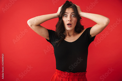 Shocked young woman wearing a dress standing