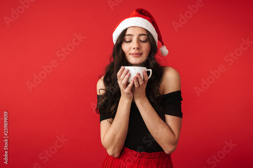 Cheerful young woman wearing Christmas hat