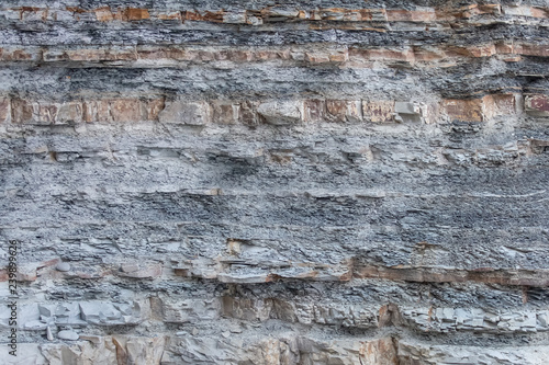 Texture Or Background Of Cut Of Breakaway Rock. Layers Of Rock Cut. Grey Layered Background