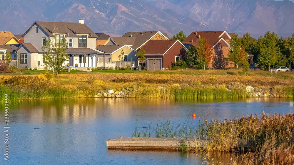 Scenic view with homes near lake against mountain