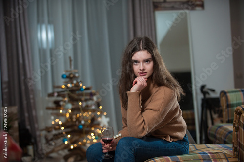 Young girl posing with a Christmas Tree