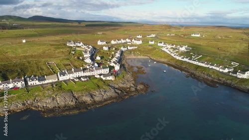 Stunning Aerial Drone Shot in Scottish Highlands, high to low reveal of Portnahaven on the Isle of Islay photo