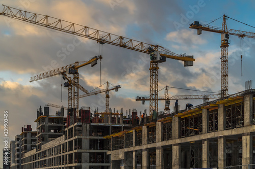 work of cranes on the construction of high-rise buildings