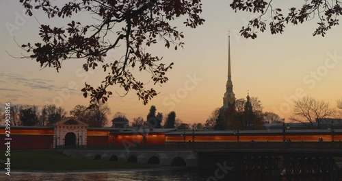 Ioannovskiy bridge and Peter and Paul Fortress at sunset, night colors, trees, river, boats, reflection on the water, pink sky, mirror, golden spike, night illumination, nobody photo