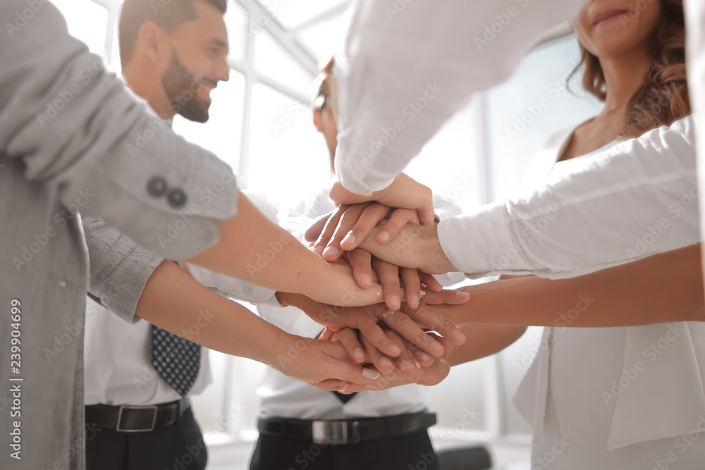 close up. business team with hands folded together close up. business team with hands folded together