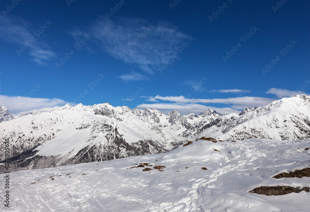 Mountains in snow and beautiful blue sky at sun winter day