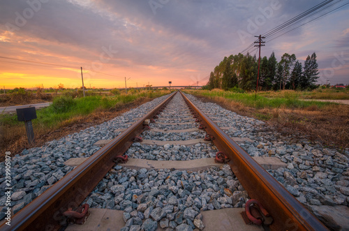 Railroad and grass field at sunrise