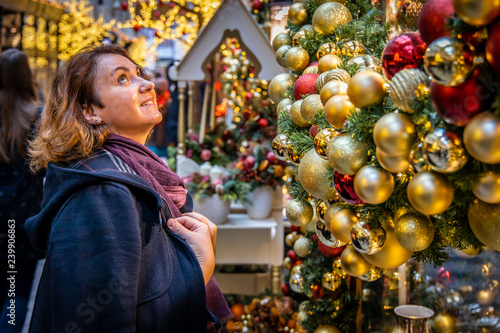 Woman doing Christmas shopping in luxury arcade, London photo