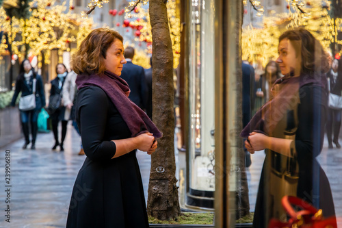 Woman doing Christmas shopping in luxury arcade, London photo