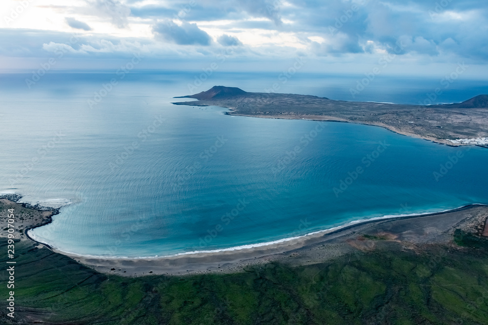 Naklejka premium View at Atlantic ocean and La Graciosa island at sunset from El Mirador del Rio in Lanzarote, Canary Islands, Spain.