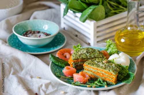 Healthy breakfast or lunch. Carrot-spinach cake with red fish  poached egg  pine nuts  lettuce and micro green.