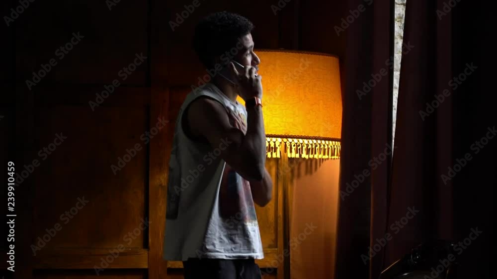 African American is worried before calling his new girlfriend, the guy in the beautiful atmospheric loft calls the girl on the phone, the man is worried, the guy is in love, the atmosphere is heavy African American is worried before calling his new girlfriend, the guy in the beautiful atmospheric loft calls the girl on the phone, the man is worried, the guy is in love, the atmosphere is heavy