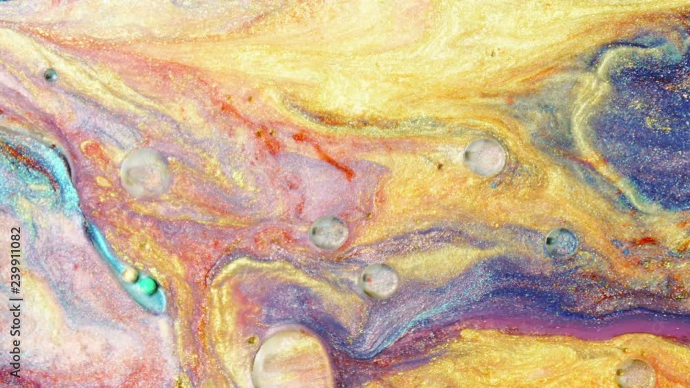 Colorful sparkling paints mix in beautiful patterns. Oil ink of yellow, red, blue, purple and other colors spread on the surface and mix one into another creating amazing textures and design. Colorful sparkling paints mix in beautiful patterns. Oil ink of yellow, red, blue, purple and other colors spread on the surface and mix one into another creating amazing textures and design.