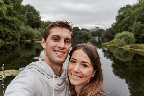 Young couple taking a selfie at park in London