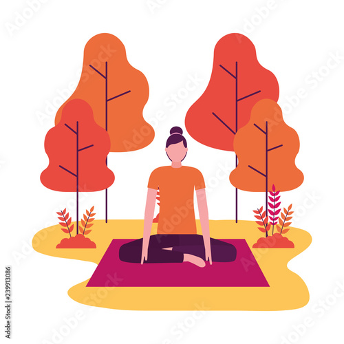 woman practicing yoga on mat in the park