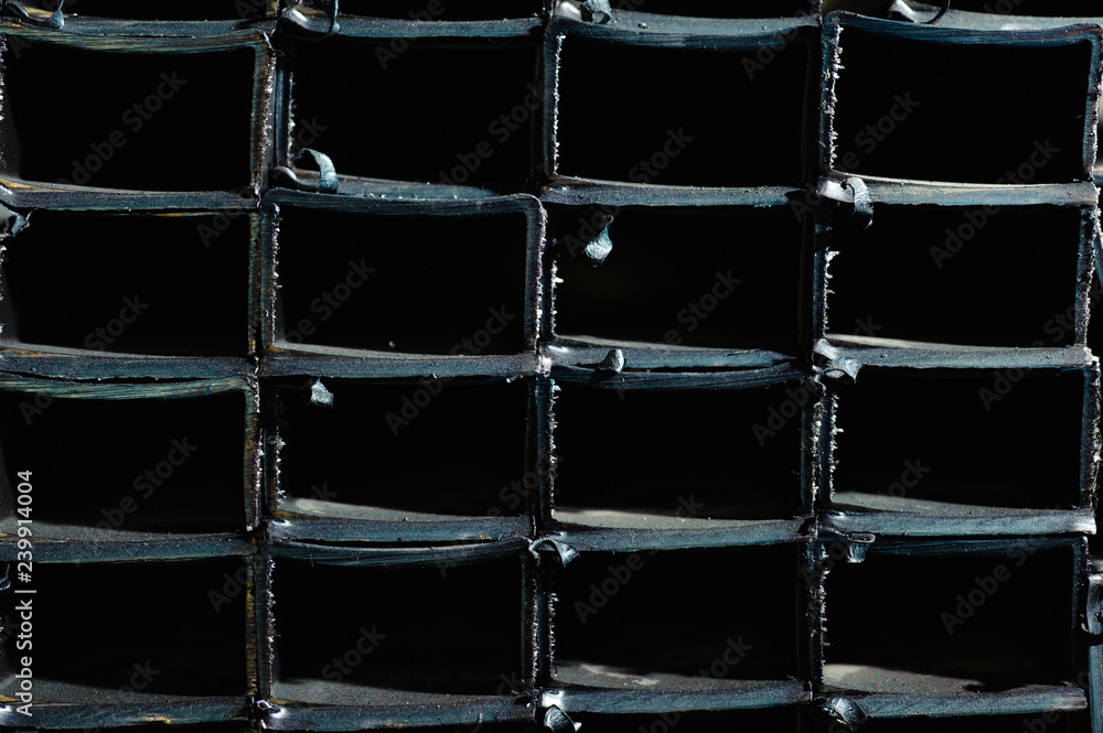 Graphical rows of black metal rectangles. Dark metal rectangles background. Graphical rows of black metal rectangles. Dark metal rectangles background.