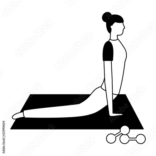 woman making yoga with mat and dumbbells