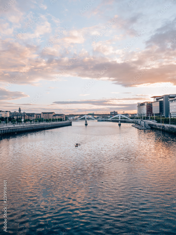 Clyde in Glasgow while sunset with a man paddling with his canoe