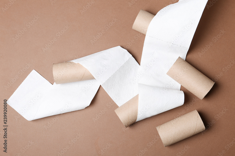 Flat lay composition with toilet paper and empty rolls on color background Flat lay composition with toilet paper and empty rolls on color background