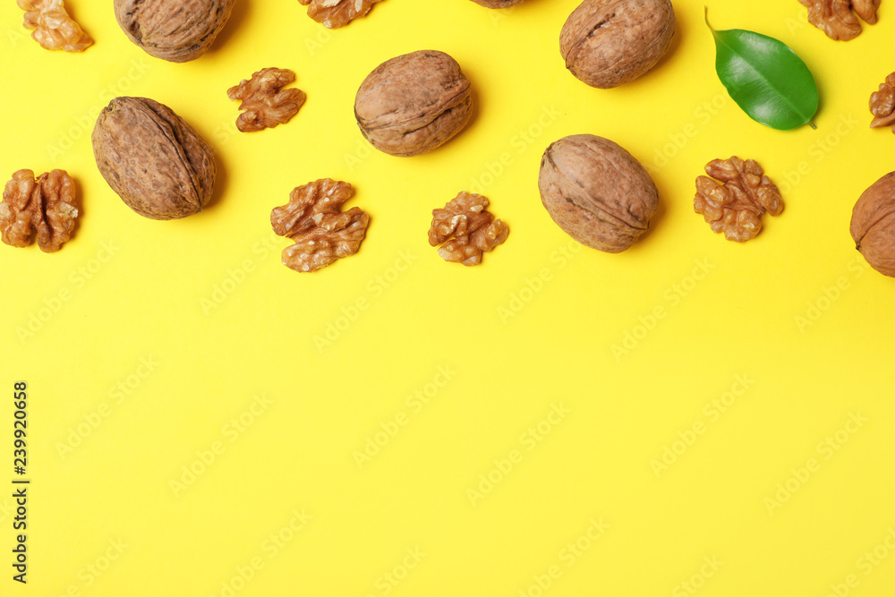 Flat lay composition with walnuts and space for text on color background Flat lay composition with walnuts and space for text on color background