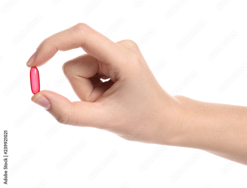 Woman holding color pill on white background, closeup Woman holding color pill on white background, closeup