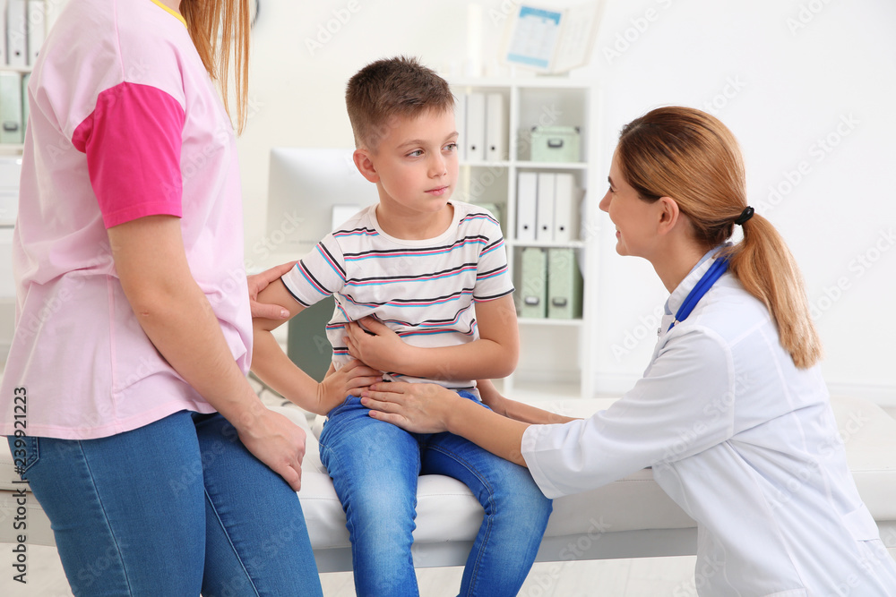Mother and son visiting pediatrician. Doctor working with patient in hospital Mother and son visiting pediatrician. Doctor working with patient in hospital