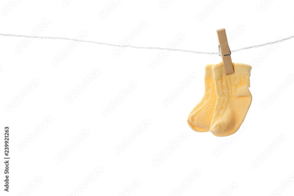 Cute child socks on laundry line against white background Cute child socks on laundry line against white background