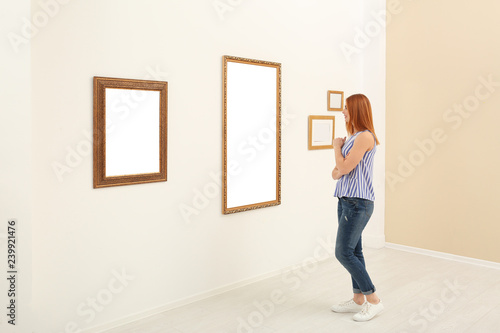 Woman viewing exposition in modern art gallery