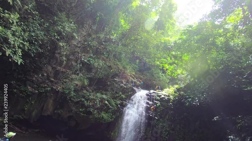 Watching fellow canyoners belaying down a waterfall in the El Diamante canyon river for canyoning convencion ca_onera cemac 2018 in Los Tuxtlas, Veracruz, Mexico photo