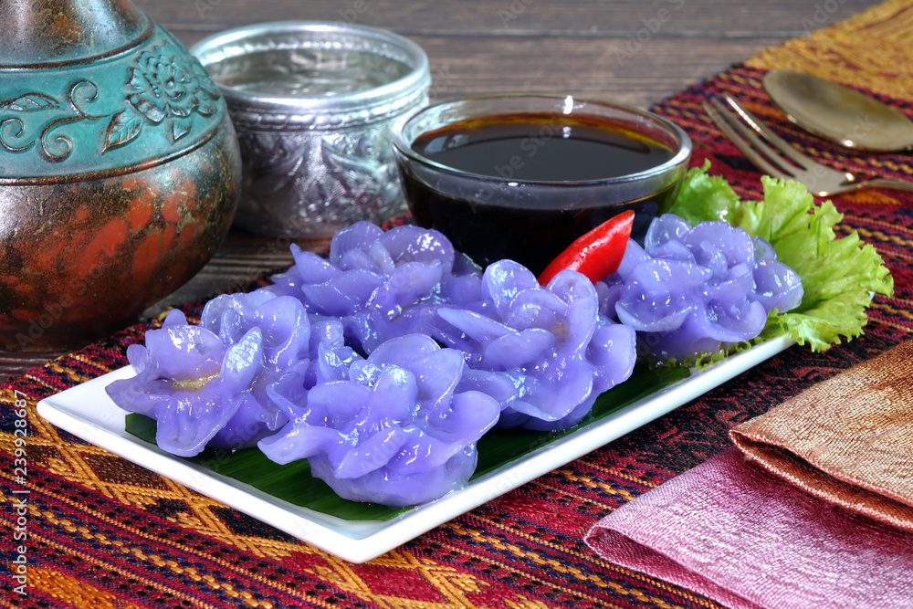 Dumpling : Purple blue color Flower-shaped Thai dumpling (Khanom Chor Muang) Famous ancient Thai appetizers.(Purple / Blue color from the Asian pigionwings flower (Butterfly / Darwin pea)) Dumpling : Purple blue color Flower-shaped Thai dumpling (Khanom Chor Muang) Famous ancient Thai appetizers.(Purple / Blue color from the Asian pigionwings flower (Butterfly / Darwin pea))