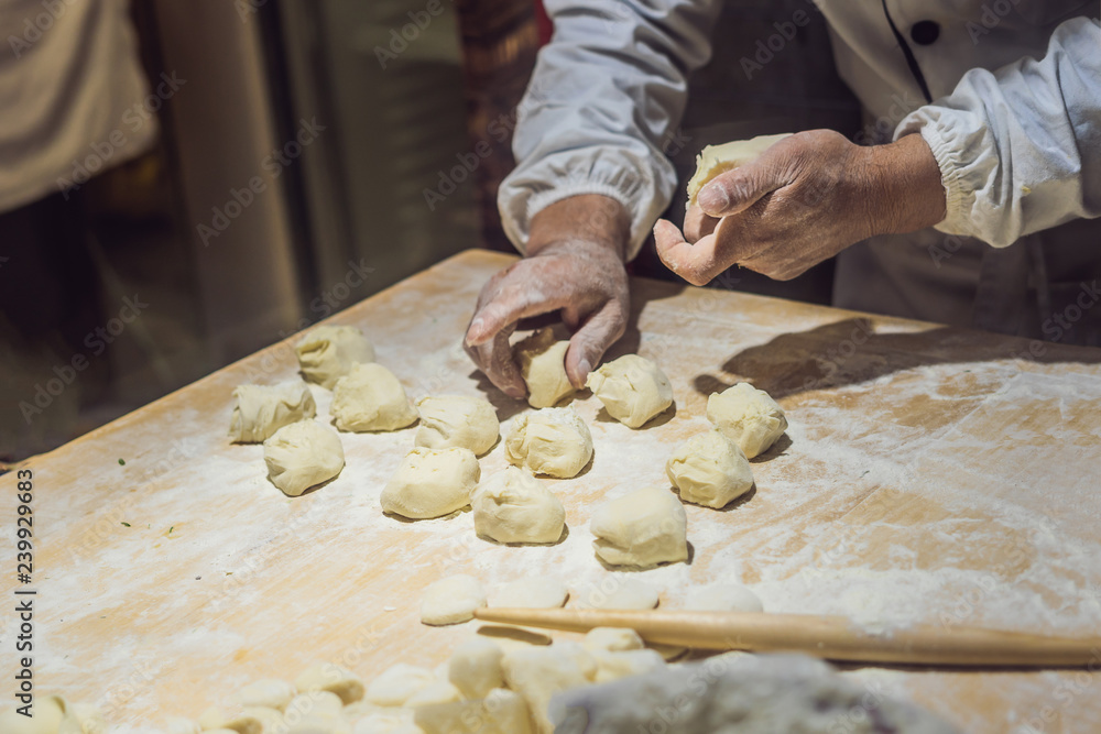 Chinese chef making dumplings in the kitchen Chinese chef making dumplings in the kitchen