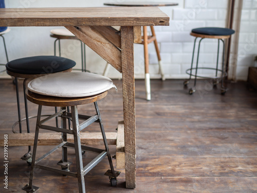 Old wooden bar stools on wooden floor in cafe retro style