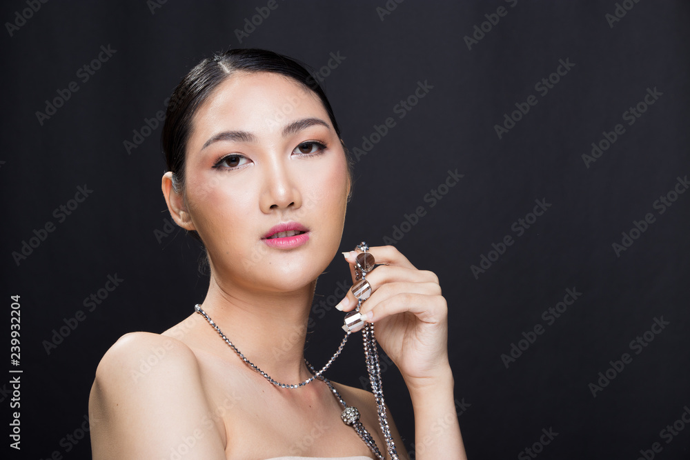 Obraz premium Beautiful Asian Long straight black hair tan skin woman in gray coat dress slim, fashion make up, studio lighting white background isolated copy space