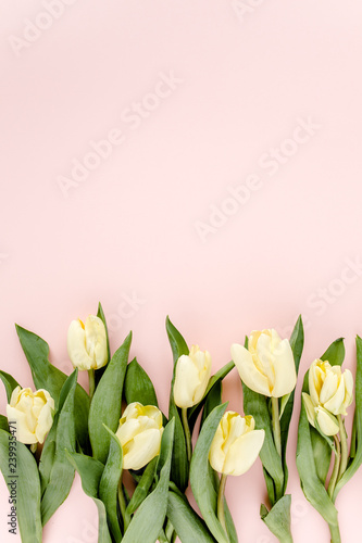 Fototapeta Naklejka Na Ścianę i Meble -  Pastel and yellow tulip flowers bouquet on pink background. Flat lay, top view. Valentine's background. Floral pattern.
