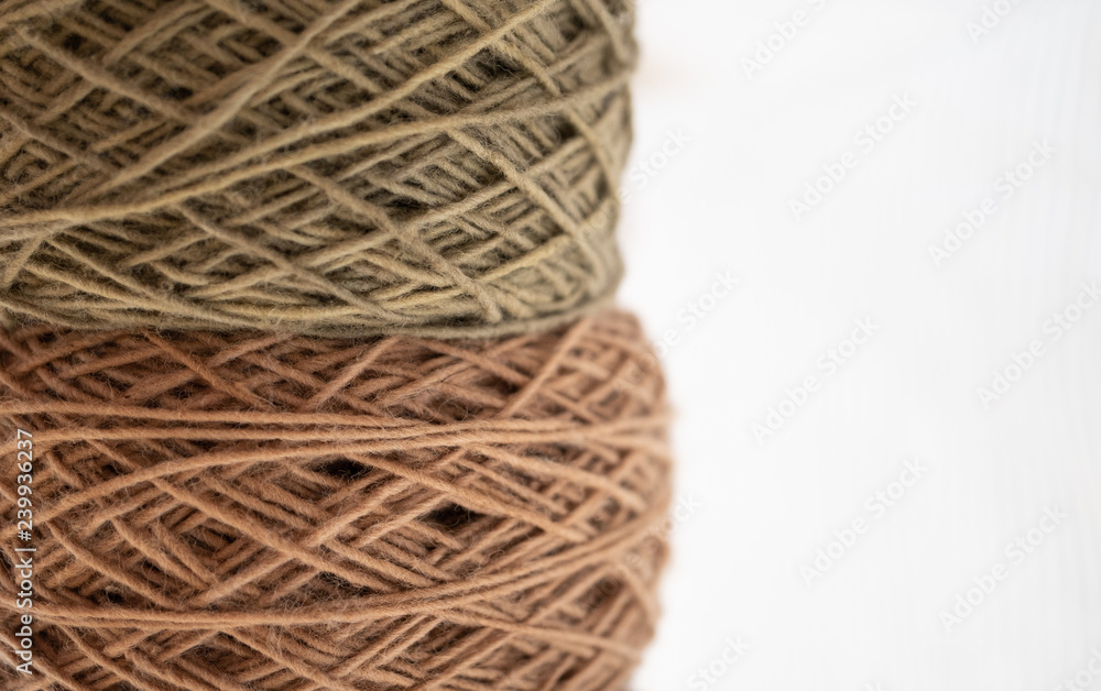roll of pastel color tone natural dye thread, white copy space on right roll of pastel color tone natural dye thread, white copy space on right