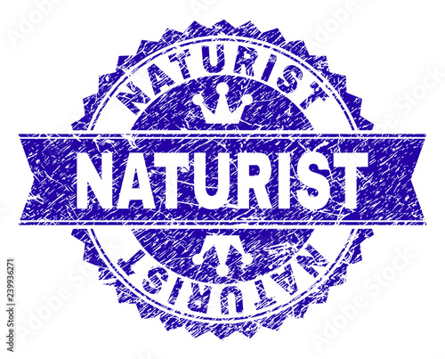 NATURIST rosette stamp watermark with grunge style. Designed with round rosette, ribbon and small crowns. Blue vector rubber watermark of NATURIST label with grunge texture.