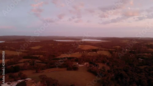 Aerial shot of the pink glow of sunset over farmland around Cardinia reservoir. photo