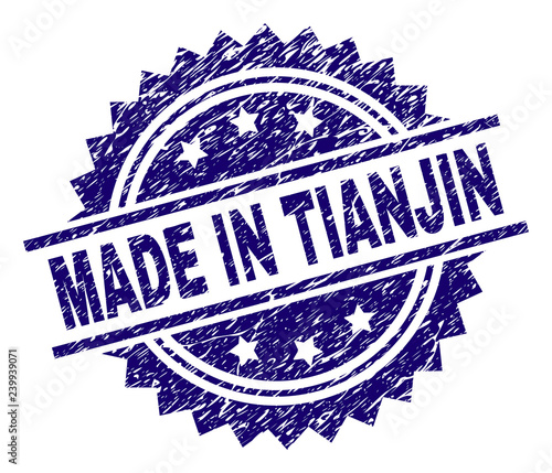 MADE IN TIANJIN stamp seal watermark with distress style. Blue vector rubber print of MADE IN TIANJIN caption with unclean texture.