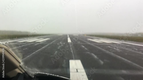 Takeoff in a private jet from a country airport on a rainy, low visibility day
