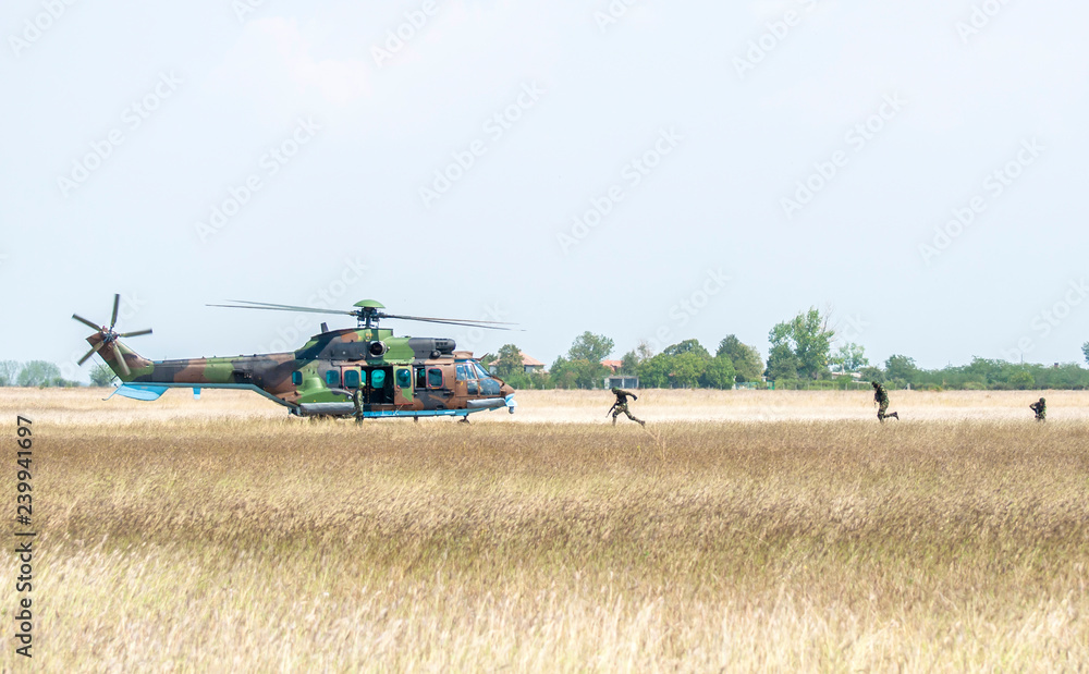 Fototapeta premium Soldiers on a rescue military operation with helicopter.