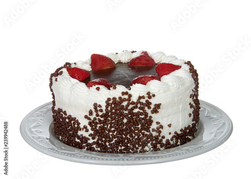Chocolate cake frosting in vanilla cream with chocolate glaze topping surrounded by fresh cut strawberries dipped in glaze Chocolate chip morsels pressed into the side of cake. Isolated on white